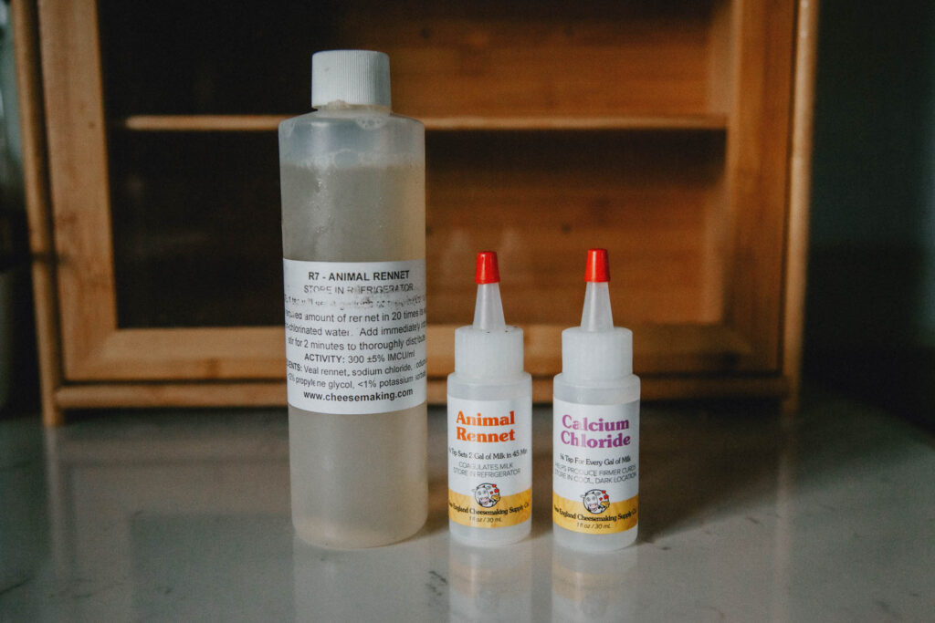 Liquid animal rennet and calcium chloride for cheesemaking.