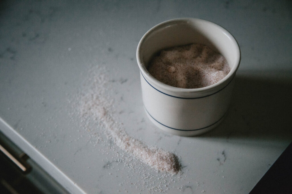 Salt in a pretty crock on a counter.