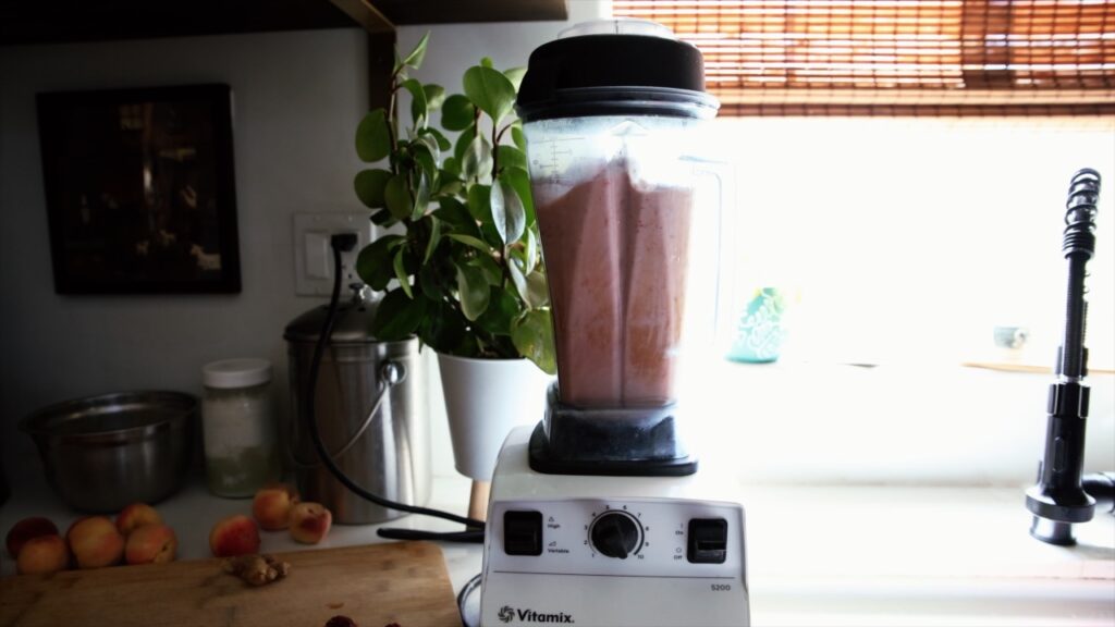 A blender full of peach puree.