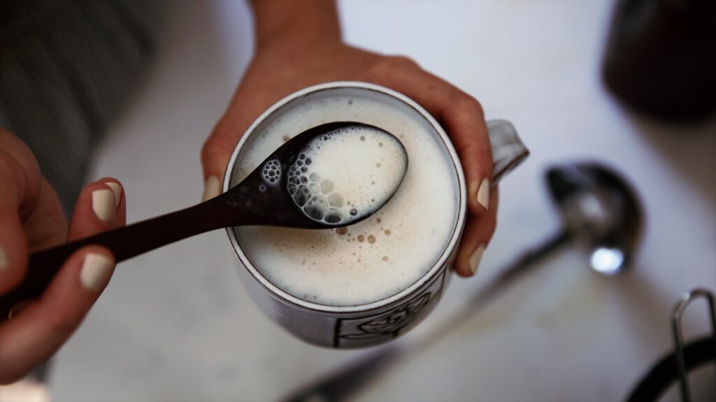 A mug full of frothy mushroom chai