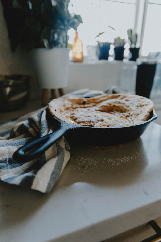 A dutch baby in a frying pan on the counter