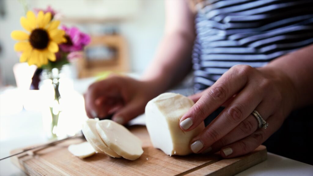 Cutting a fresh ball of goat milk mozzarella.